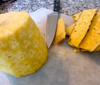 Photo of fresh pineapple being trimmed / www.super-seafood-recipes.com