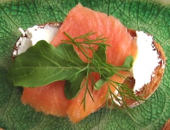 Photo of Brushetta with a layer of chevre, smoked salmon, arugula, and dill / www.super-seafood-recipes.com