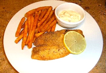 Picture of pan-fried tilapia, ready to serve with spicy French fries/ www.super-seafood-recipes.com