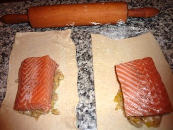 Photo of Salmon filets placed on top of leek mixture on puff pastry rectangles/ www.super-seafood-recipes.com